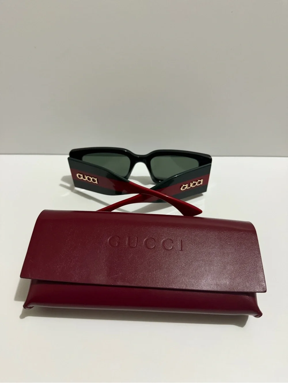 Gucci Black Frame Sunglasses with Red Temples and Gold Logo